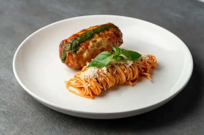 Homemade cordon bleu and basilico pasta plated together at Secret Oven restaurant