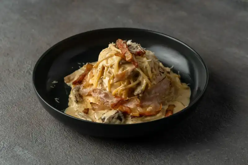 Authentic carbonara pasta made with guanciale and Pecorino Romano cheese at Secret Oven Koh Samui