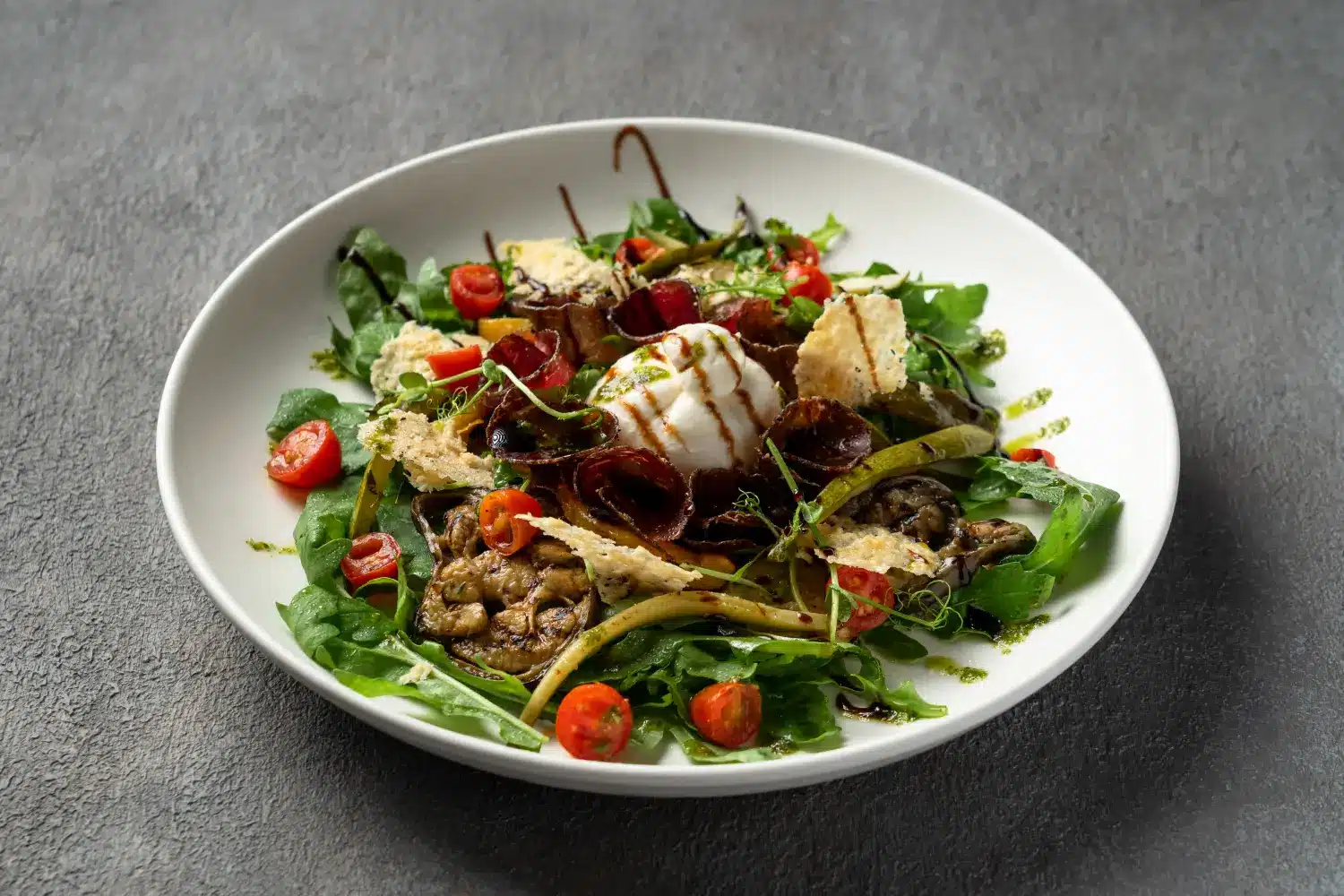 Homemade salad with Italian bresaola, creamy burratina, and rocket leaves at Secret Oven restaurant