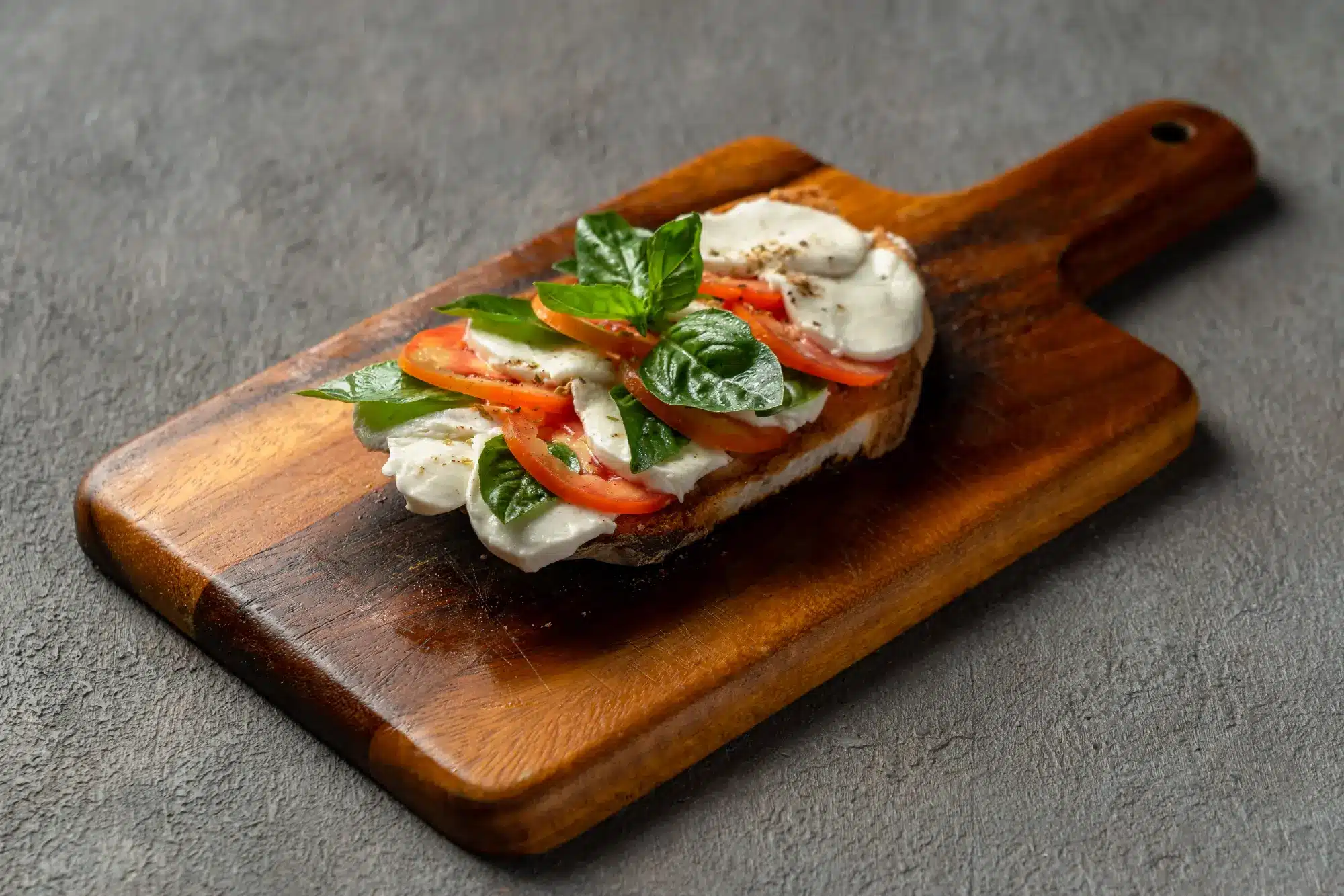 Crispy bruschetta topped with fresh tomatoes, mozzarella, and basil at Secret Oven Koh Samui