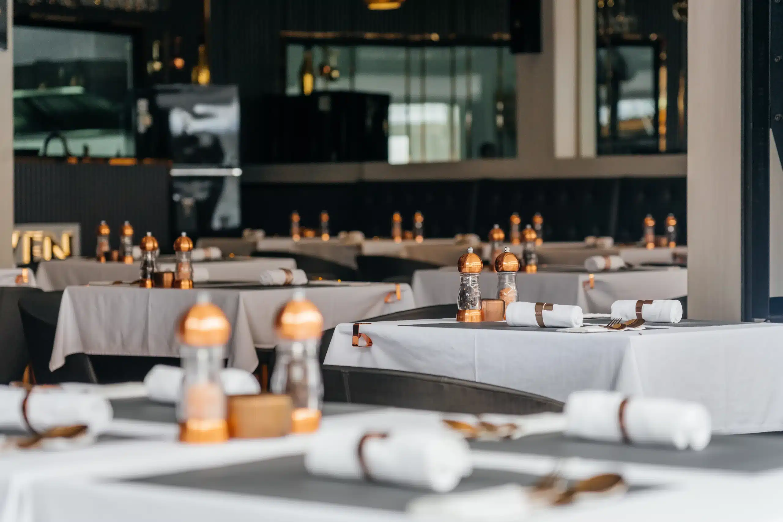 Secret Oven restaurant interior featuring wooden tables, warm lighting, and artisan artwork