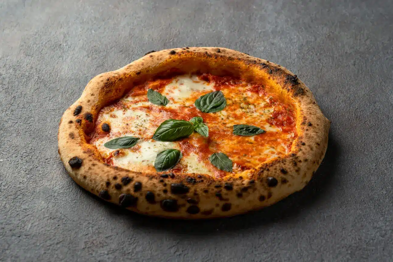 Homemade Margherita pizza baked with fresh tomatoes, mozzarella, and basil at Secret Oven restaurant