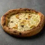 Homemade Pizza Miele topped with Italian cheese, honey drizzle, and nuts at Secret Oven restaurant